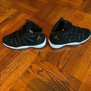 Air Jordan 11 Retro Preium in black w/ gold accent